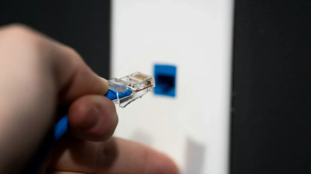 Network cable being plugged into a wall data point